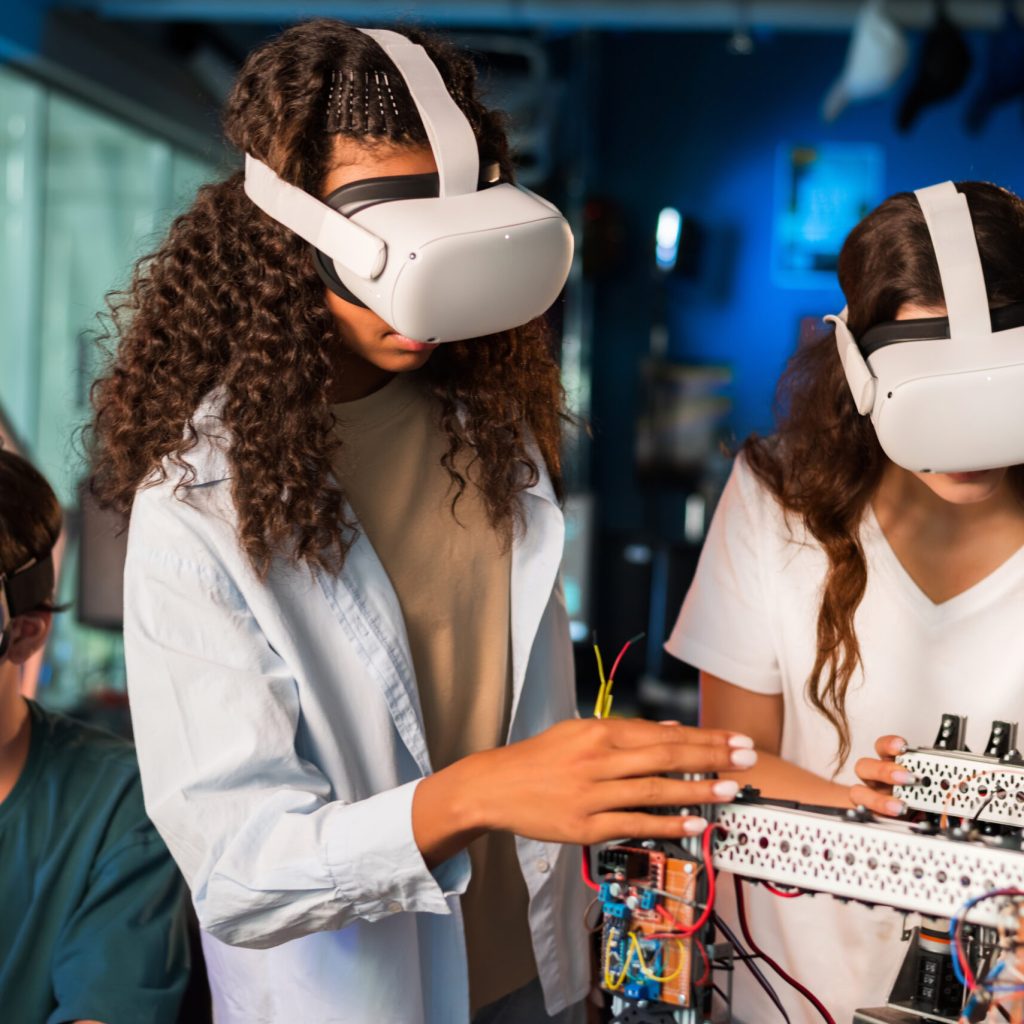 Group of young people in VR glasses doing experiments in robotics in a laboratory. Robot on the table
